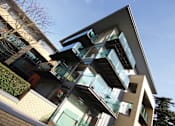 Thumbnail 5 of 9 - a building with windows and a blue sky
