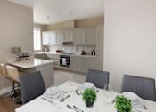 Thumbnail 4 of 9 - a kitchen and dining room with a table and chairs