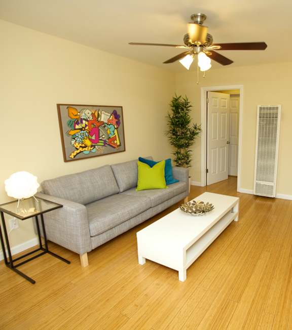 a living room with a couch and a ceiling fan