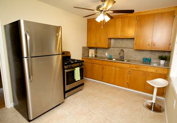 a kitchen with stainless steel appliances and wooden cabinets