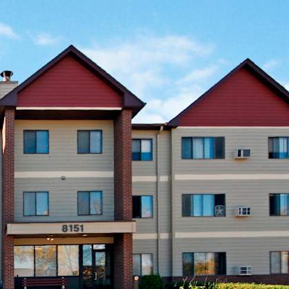 A large apartment building with the number 8151 on the front.