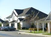 Thumbnail 1 of 3 - a row of houses with cars parked in front of them