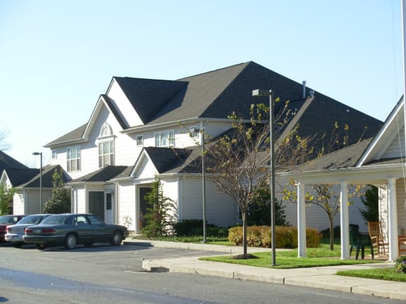 a row of houses with cars parked in front of them