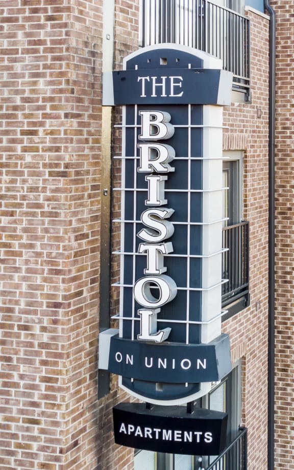 a tall brick building with a sign for the baths on the side  at Bristol On Union Apartment Homes, Memphis, TN, 38104