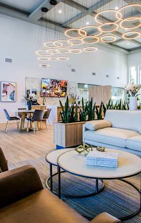 A modern living room with a variety of seating options and a coffee table.