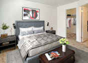 Thumbnail 3 of 17 - Bridgeside Landing Apartments in Taylorsville, Utah, large double bed with two nightstands, grey bedding, walk-in closet.
