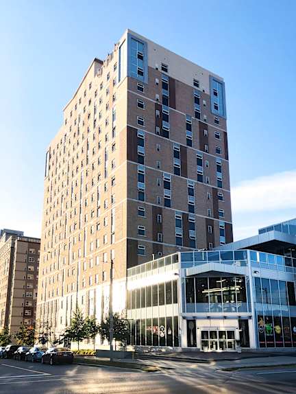 A tall building with a lot of windows is in the foreground.