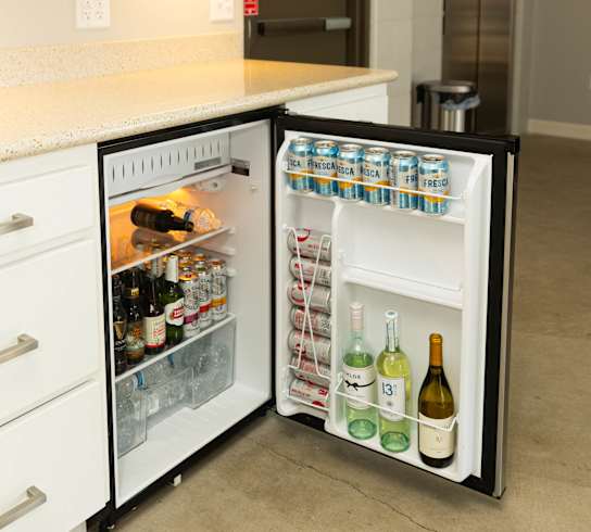 an open refrigerator in a kitchen with a counter top