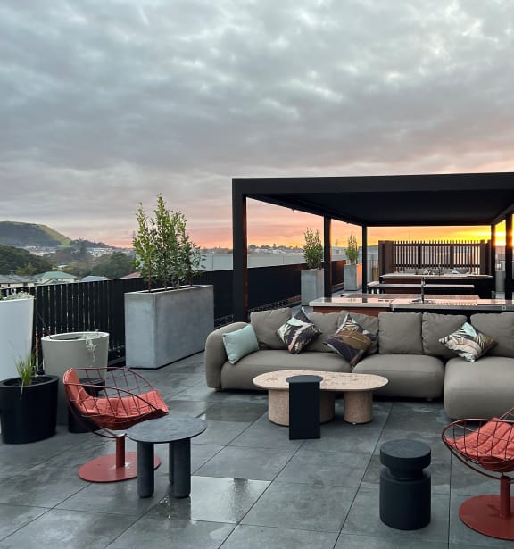 a terrace with couches and tables on a roof top