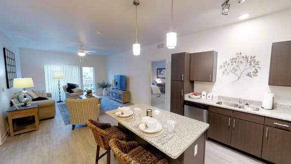 a kitchen and living room with a table and chairs