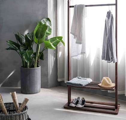 a bathroom with a towel rack and a plant