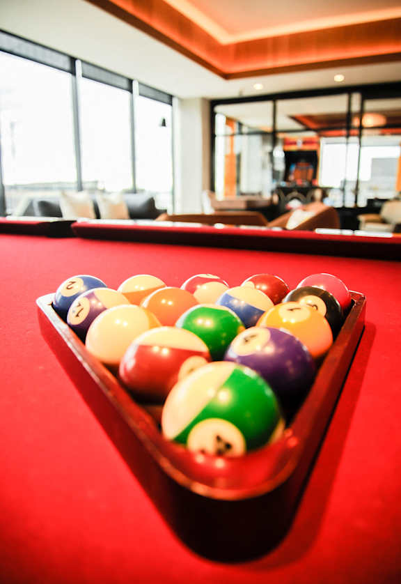 a rack of pool balls on a red pool table