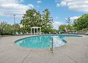 Thumbnail 1 of 5 - A pool with a diving board and a gazebo in the background.