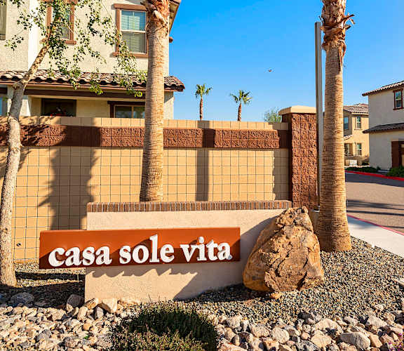 Two palm trees stand in front of a sign that says  at Casa Sole Vita Townhomes, Mesa, 85208
