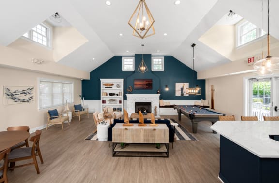 a large living room with a pool table and a dining room  at Spa Cove Apartments, Annapolis, Maryland