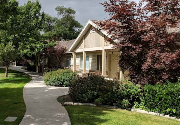 an exterior view of a building with brick pillars and a walkway