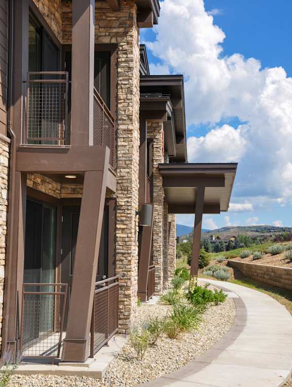 A modern house with a curved walkway in front.