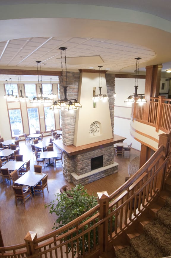 a view of the dining area of a restaurant with a fireplace