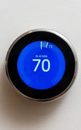 A digital thermostat shows a temperature of 70 degrees.