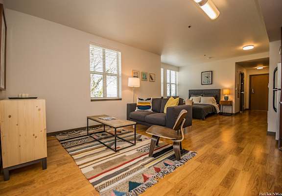 Portland OR Apartments - Corbett Heights Living Room in Our Studio Apartments With Cozy Decor and Hardwood-Style Floors