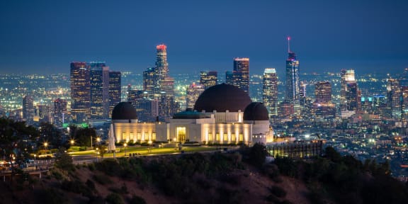 the observatory at night with the city skyline in the background at Binford Lofts Apartments, Los Angeles