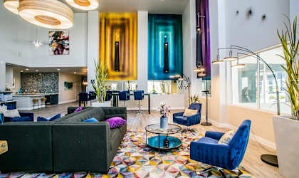 a living room with couches and chairs and a spiral staircase