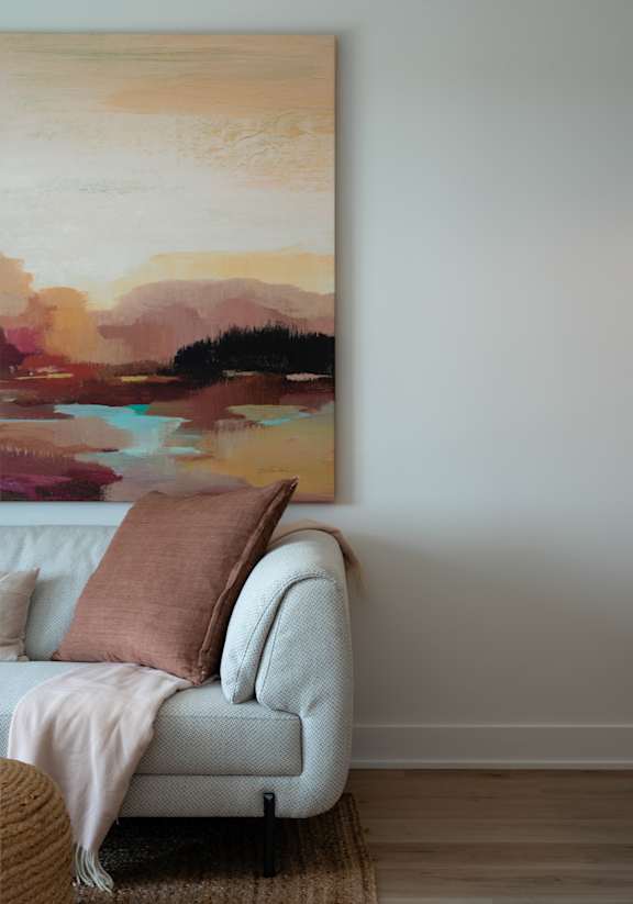 A living room with a white couch and a large window.