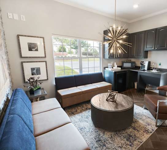 A modern living room with a large sectional sofa and a coffee table.