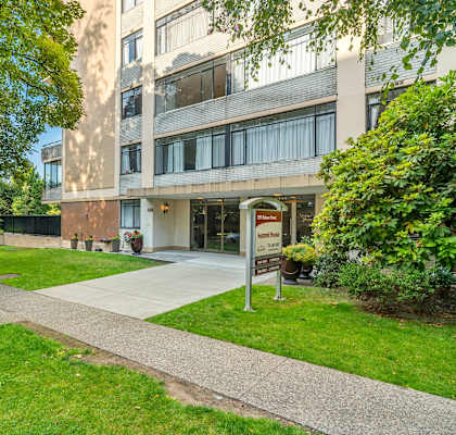 A building with a green lawn in front of it.