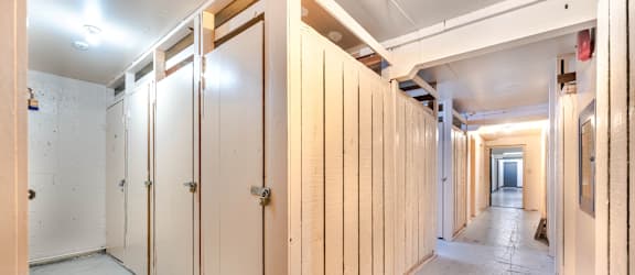 A long hallway with wooden doors on both sides.