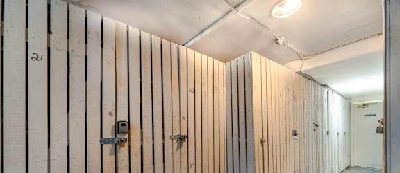 A long hallway with wooden walls and doors.