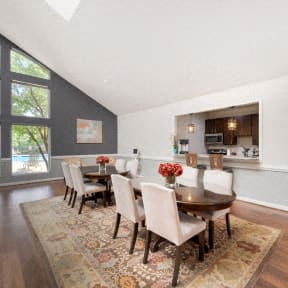 a dining room with a wooden table and chairs
