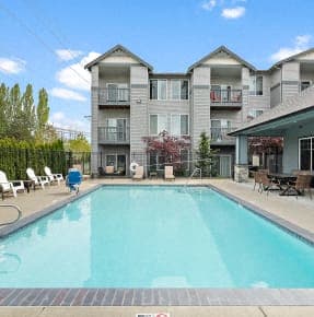 a swimming pool with a building in the background