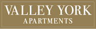 A brown sign that says "Valley York Apartments".