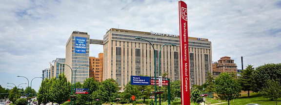 a view of a city with tall buildings and street signs