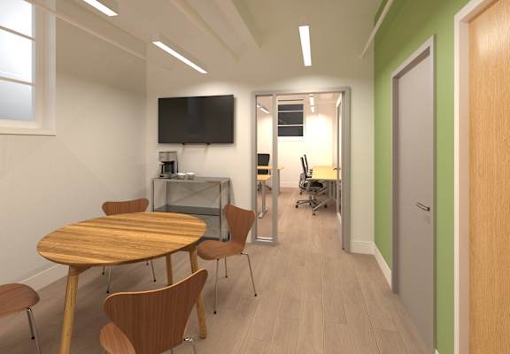 a conference room with a table and chairs and a television