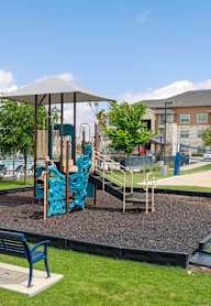 A playground with a slide and two benches.