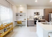 Thumbnail 12 of 21 - A modern kitchen with a white countertop and a wooden rolling cart.