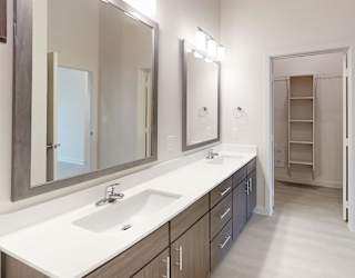 A bathroom with a sink, mirror, and medicine cabinet.