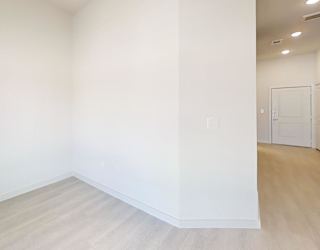 A room with white walls and wooden flooring.