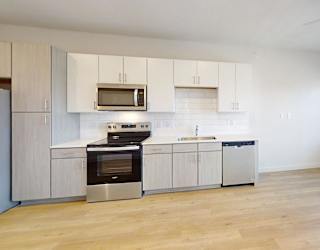 A kitchen with a stove, oven, and microwave.