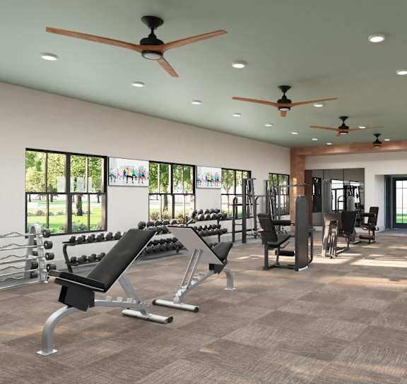 a gym with weights and cardio machines and a large sign on the floor at The Quinn, Pensacola, FL, 32526