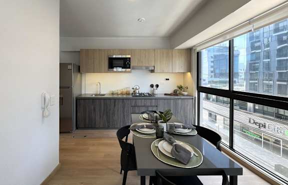 A dining area with a table set for two.