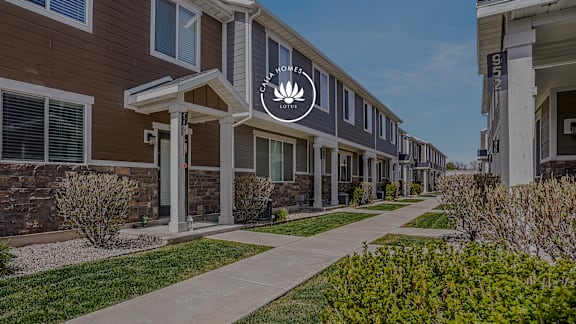 A row of houses with a logo on the front of the first one.