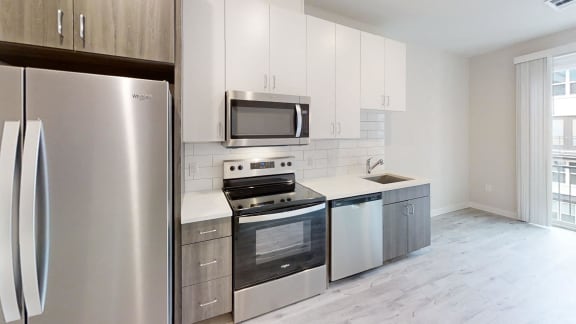 a kitchen with stainless steel appliances and white cabinets