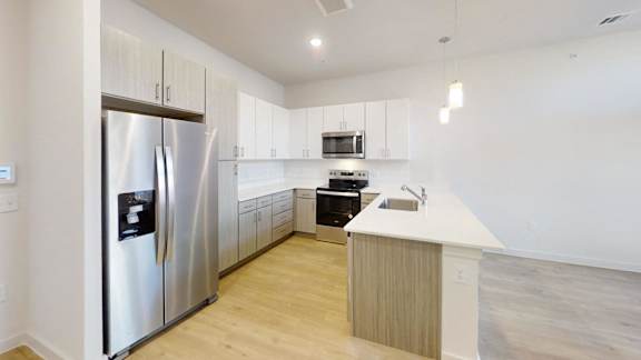 A modern kitchen with a stainless steel refrigerator and wooden countertops. at Park South Apartments, Austin, TX, 78748