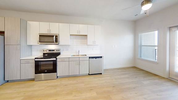 A kitchen with a stove, oven, and microwave.