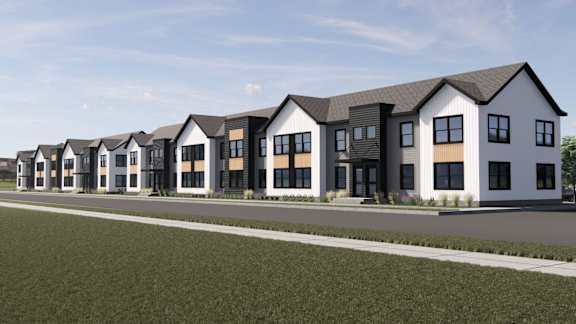 A row of modern houses with white walls and black roofs.