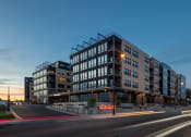 Thumbnail 52 of 53 - a large building with a street in front of it at night