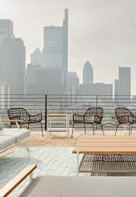 a rooftop patio with a view of a city skyline